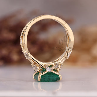 Custom emerald and diamond engagement ring.