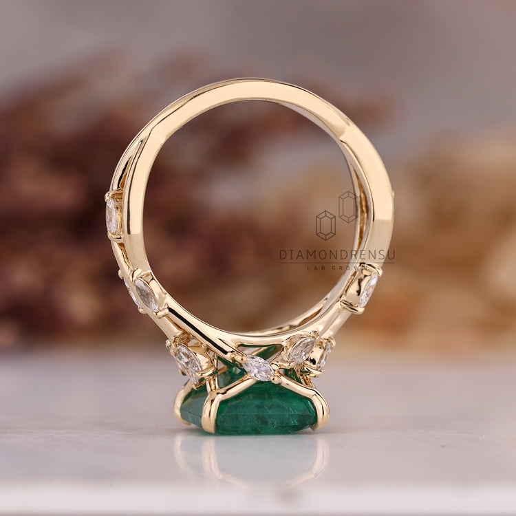 Custom emerald and diamond engagement ring.