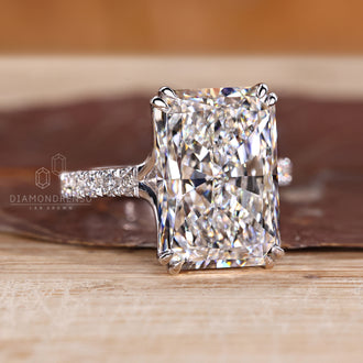 Radiant cut diamond ring with double claw prong setting.