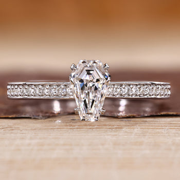 Coffin cut diamond ring with pave style band and round diamond accents.