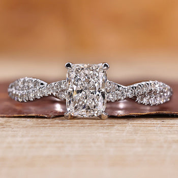 Twisted pave engagement ring with round cut diamonds in white gold.