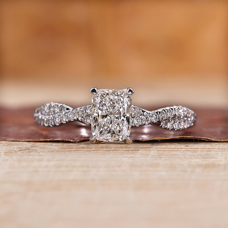 Twisted pave engagement ring with round cut diamonds in white gold.
