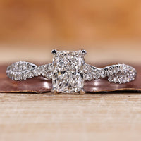 Twisted pave engagement ring with round cut diamonds in white gold.