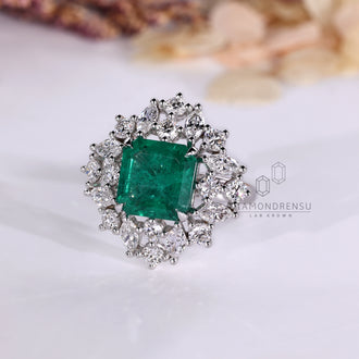 Cluster style emerald engagement ring.