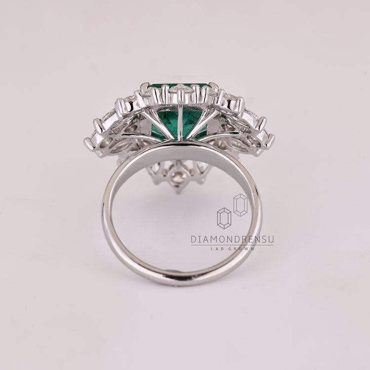 Custom emerald and diamond engagement ring.