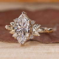 IGI certified nature inspired engagement ring with marquise center diamond.