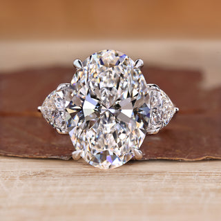 Three stone oval engagement ring with trillion sides.