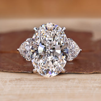 Three stone oval engagement ring with trillion sides.
