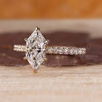 Custom diamond ring with Dutch marquise design and pave accents.