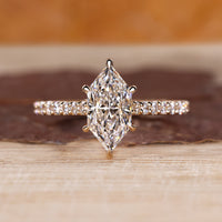 Dutch marquise engagement ring with pave setting and round cut pave band.