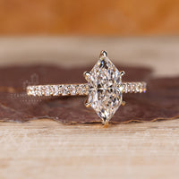 Handmade ring featuring marquise diamond and round cut pave band.