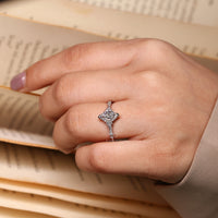 Round cut side stone diamond ring in a vintage inspired style.