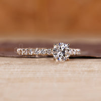 Round cut pave band engagement ring designed in yellow gold.