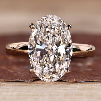 Oval hidden halo engagement ring design.