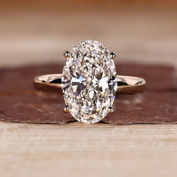 Oval hidden halo engagement ring design.