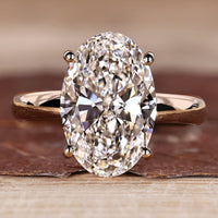 Oval hidden halo engagement ring design.