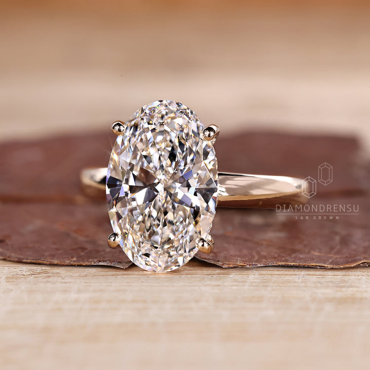 Four prong setting oval diamond ring.