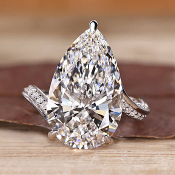 Pear cut diamond ring with pave band.