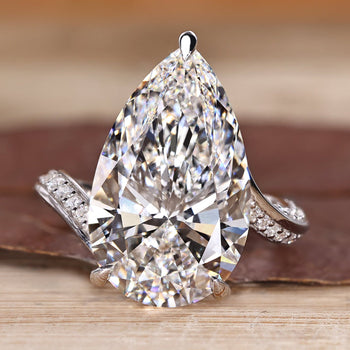 Pear cut diamond ring with pave band.