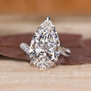 Pear cut diamond ring with pave band.