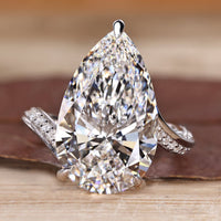 Pear cut diamond ring with pave band.