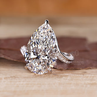 Pear diamond ring with bypass setting.