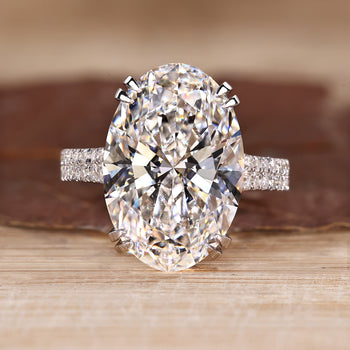 Oval diamond engagement ring with pave band.