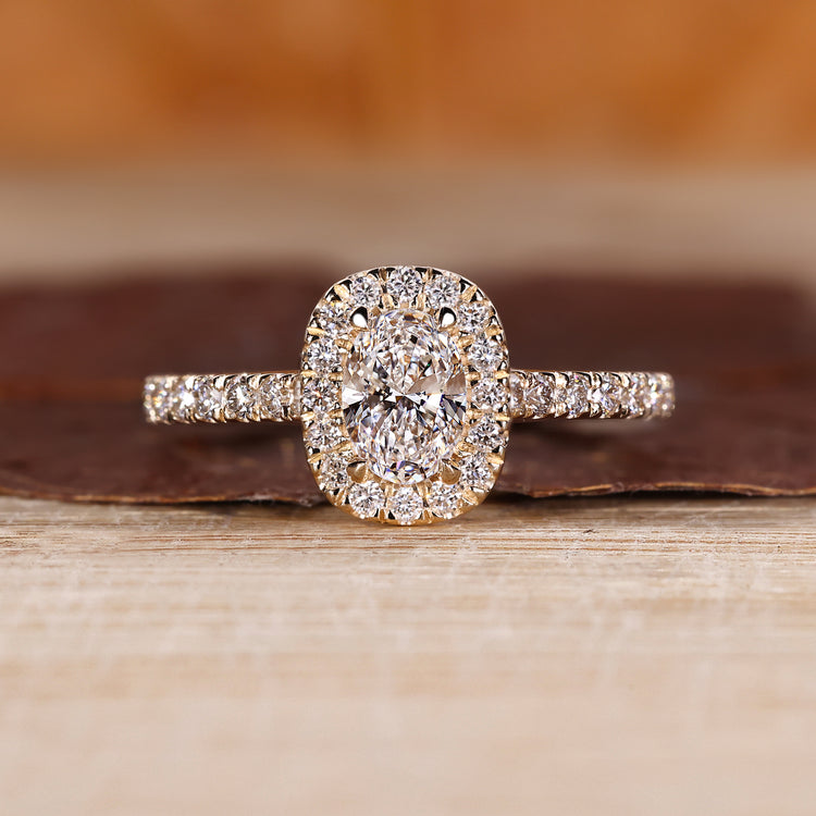 Oval cut diamond ring with halo setting.