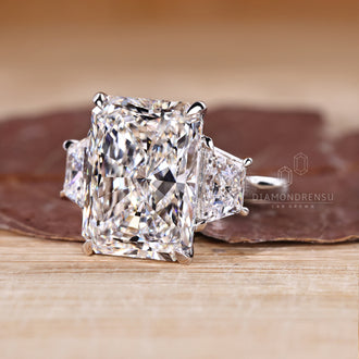 Cathedral setting ring with radiant cut center diamond.