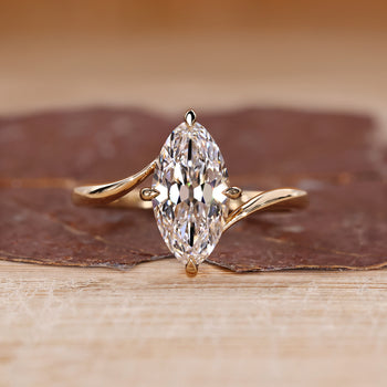 Bypass diamond ring with marquise old European cut diamond in solitaire setting.