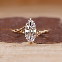 Bypass diamond ring with marquise old European cut diamond in solitaire setting.
