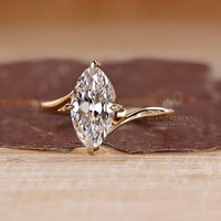 Marquise old European cut diamond solitaire ring with unique bypass style.