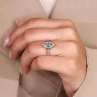 IGI certified three stone ring with marquise and pear shaped diamonds.