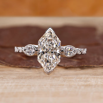 Three stone diamond ring with Dutch marquise and pear side stones.