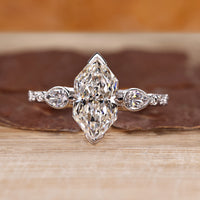 Three stone diamond ring with Dutch marquise and pear side stones.