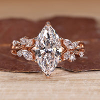 Marquise cut diamond ring with marquise and round side stones.