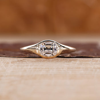 Old mine cushion cut diamond ring in east to west solitaire setting.