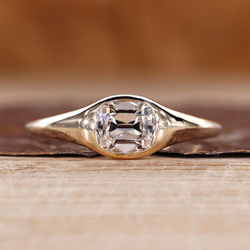 Old mine cushion cut diamond ring in east to west solitaire setting.