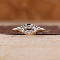 Old mine cushion cut diamond ring in east to west solitaire setting.