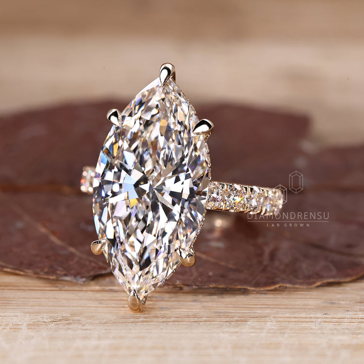 Pave round diamond ring with marquise center.