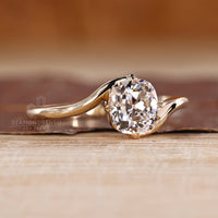 Handmade ring featuring yellow gold band and cushion OEC diamond.