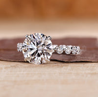 Round diamond ring with bubble pave band.