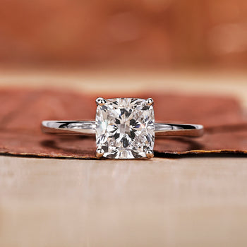 A cushion cut engagement ring with a classic and elegant design in a soft velvet box.