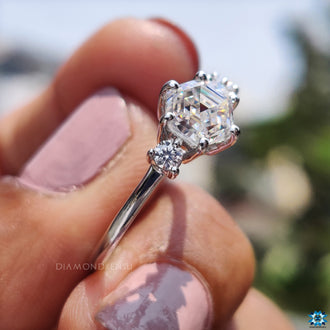 Buy moissanite ring featuring round cut side stones and prong setting.