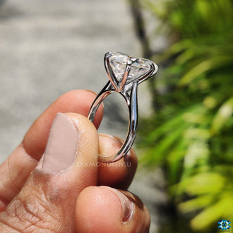 Cathedral setting engagement ring featuring a custom pear moissanite.