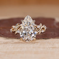 Pear shaped diamond ring with nature inspired design.