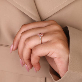 Halo Ring featuring a brilliant pink diamond centerpiece.