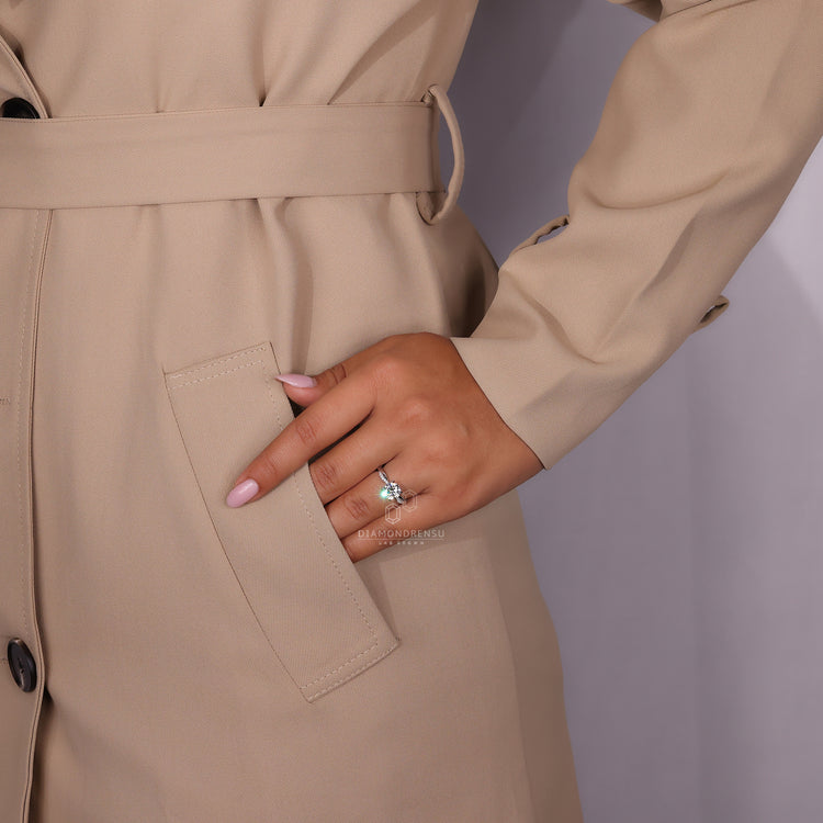 Beautiful ring with a 4 prong claw setting on a model's hand.