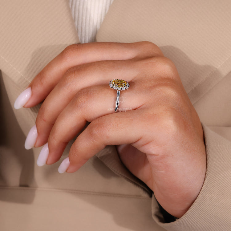 White gold engagement ring with oval diamond and four claw prong setting.