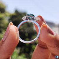 Exquisite moissanite oval ring with a cyan blue moissanite center stone